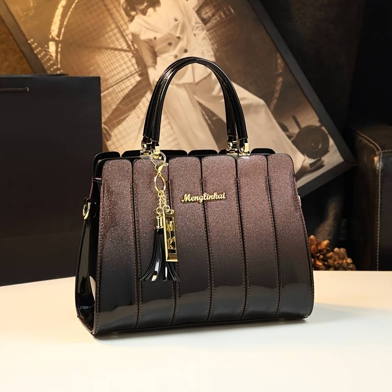 Elegant sequin patent handbag with zipper closure.